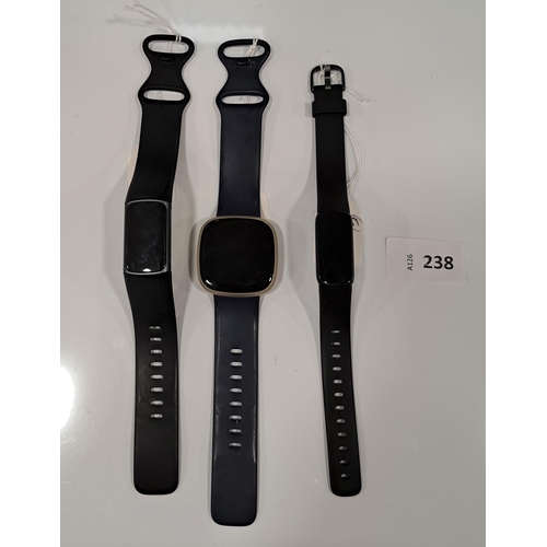 238 - THREE FITBIT FITNESS TRACKERS
comprising a Luxe, a Versa 3 and a Charge 5