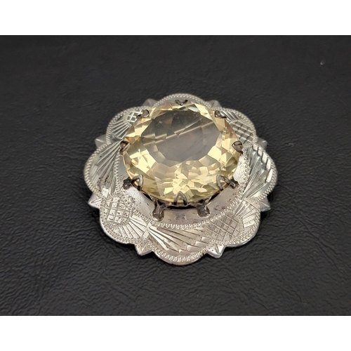 32 - LARGE CITRINE SET SILVER BROOCH
the central round cut citrine measuring approximately 24mm x 24mm x ... 