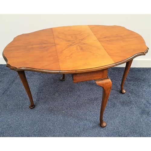 321 - WALNUT OCCASIONAL TABLE
with shaped drop flaps, standing on cabriole supports, 61cm wide