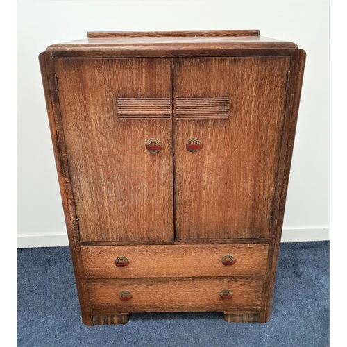 411 - ART DECO LIMED OAK CABINET
with a raised back above a pair of cupboard doors with a shelved interior... 