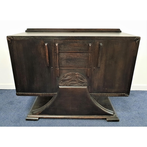 389 - 1920s OAK SIDE CABINET
with a raised back above three central drawers, one carved with stylised moti... 