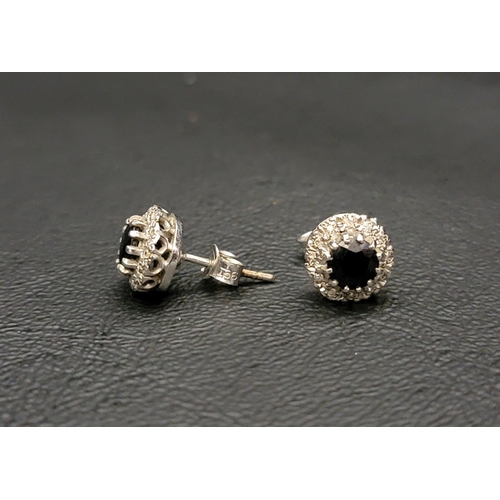 17 - PAIR OF SAPPHIRE AND DIAMOND CLUSTER EARRINGS
in nine carat white gold, the central sapphire on each... 