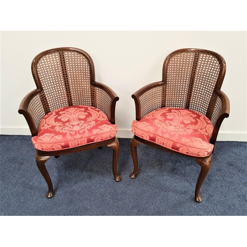 327 - PAIR OF MAHOGANY ARMCHAIRS
with shaped caned backs, arms and seats with cushions, standing on cabrio... 