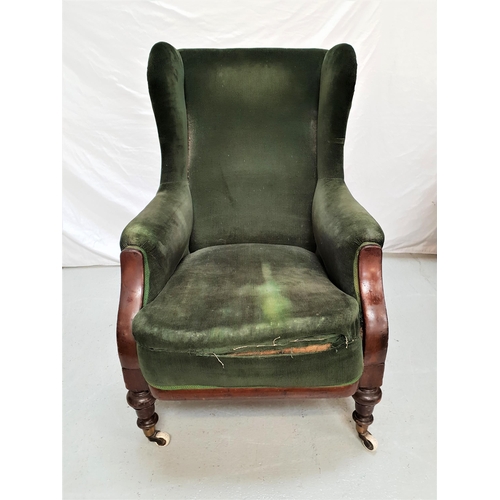 381 - VICTORIAN MAHOGANY WING BACK ARMCHAIR
with a padded back, arms and seat covered in a green corduroy,... 