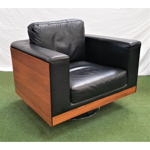 386 - DWELL WALNUT AND LEATHER ARMCHAIR
on a circular steel swivel base