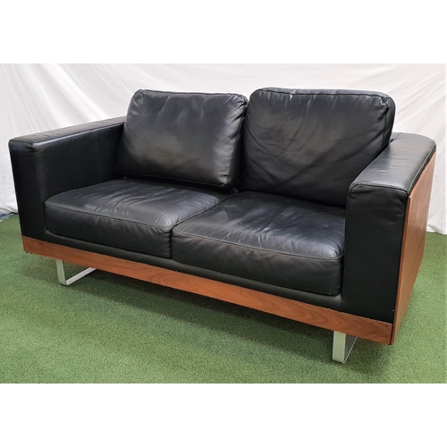 387 - DWELL WALNUT AND LEATHER SOFA
with a shaped frame and on shaped steel supports, 161cm wide