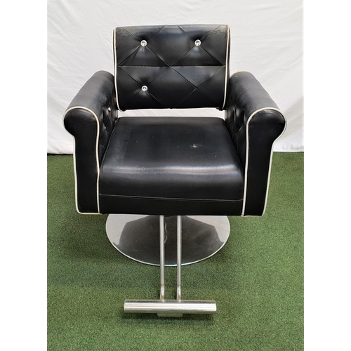 406 - BARBERS STYLE ARMCHAIR
covered in black vinyl with a contrast cream piping and diamanté button back,... 