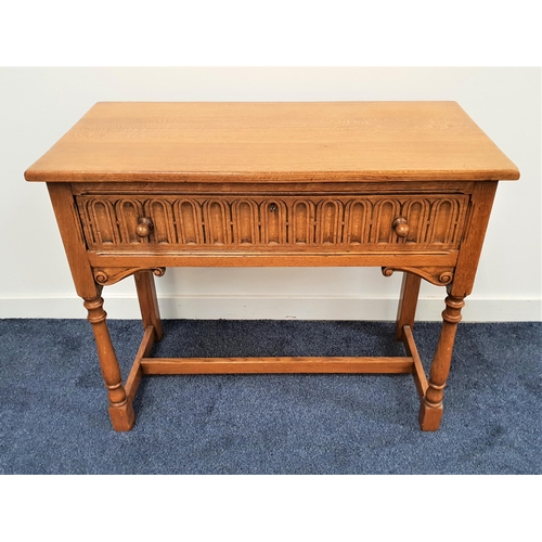 414 - OAK SIDE TABLE
with carved drawer raised on turned front and plain back supports united by a stretch... 