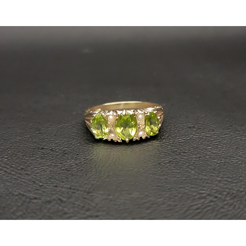 68 - PERIDOT AND SEED PEARL THREE STONE RING 
the three graduated oval cut peridots measuring approximate... 