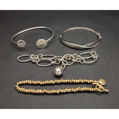 72 - SELECTION OF FOUR SILVER BRACELETS
comprising a gilt beaded bracelet with a T-bar fastening, a fancy... 