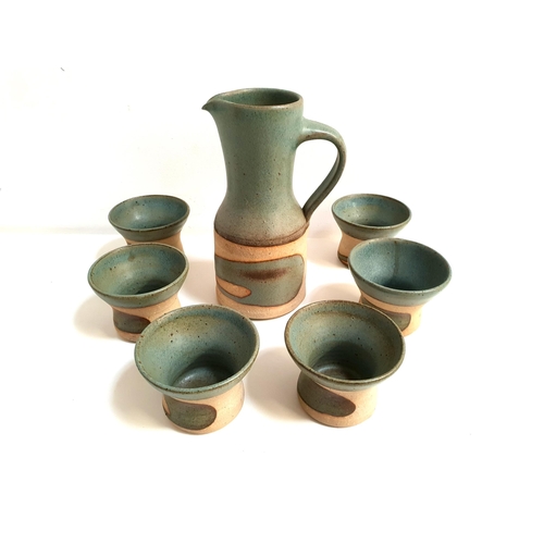 188 - STUDIO POTTERY WATER JUG AND SIX BEAKERS BY ARNAUD BARRAUD
all with irregular patterned green glaze,... 