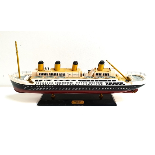 219 - PAINTED WOODEN MODEL OF THE TITANIC 
on wooden plinth stand with plaque marked 'Titanic 1912', 49cm ... 