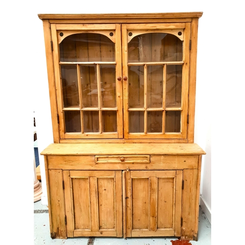 391 - WAXED PINE DRESSER
with a pair of glass panel cupboard doors opening to reveal a shelved interior, t... 