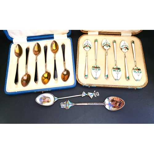 160 - TWO CASED SETS OF ENAMEL DECORATED SILVER COFFEE SPOONS
one set with stylised motif decoration on a ... 