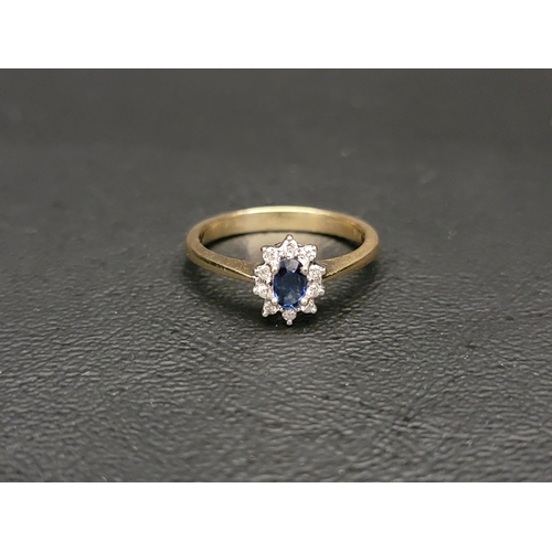 22 - PRETTY SAPPHIRE AND DIAMOND CLUSTER RING
the central oval cut sapphire approximately 0.25cts in ten ... 