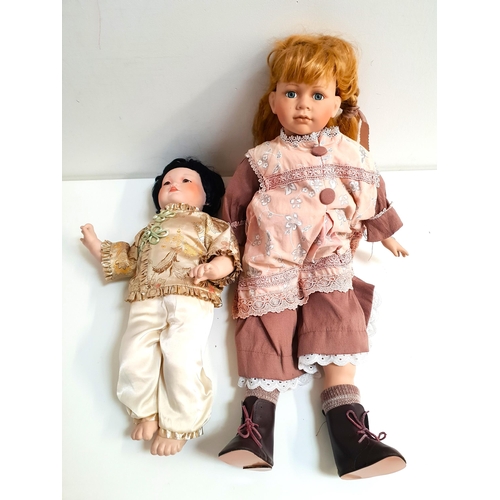 281 - TWO BISQUE HEADED DOLLS
one a Franklin Heirloom dolls Chinese doll dated 1987, 53cm long; the other ... 