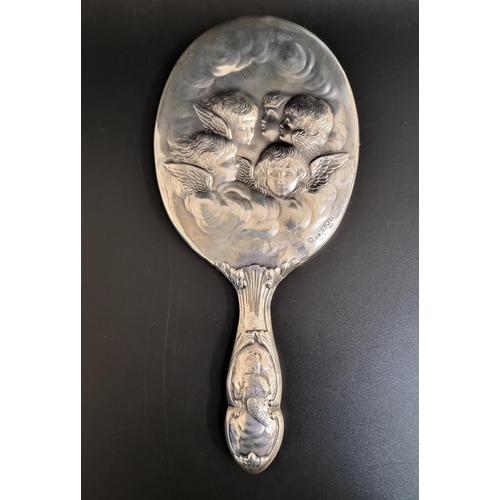 152 - EDWARD VII SILVER HAND MIRROR
with embossed cherub decoration to the mirror back and both sides of t... 