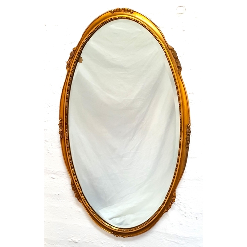 322 - OVAL WALL MIRROR
with a giltwood frame and bevelled plate, 73cm high