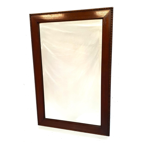 324 - MAHOGANY RECTANGULAR WALL MIRROR
with a bevelled plate, 68.5cm x 46cm