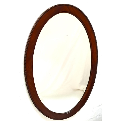 328 - OVAL MAHOGANY WALL MIRROR
with a bevelled plate, 74.5cm x 49.5cm