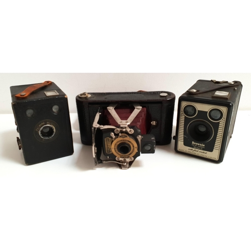 238 - THREE VINTAGE CAMERAS
comprising a No. 1 folding pocket kodak camera in case; and two box brownie ca... 