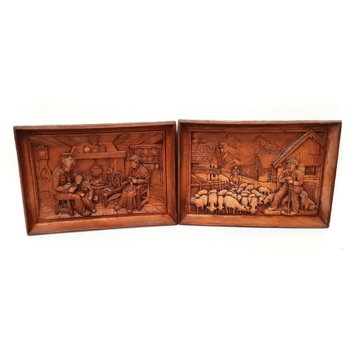 252 - PAIR OF BAVARIAN CARVED TEAK PANELS
one depicting a family seated by the fire, the other a shepherd ... 