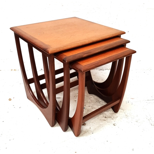 444 - NEST OF THREE G PLAN TEAK TABLES
each with a square top standing on continuous supports, the largest... 