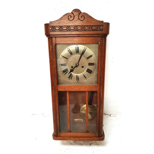 445 - AMERICAN WALL CLOCK
in oak case with a silvered dial and eight day movement, with pendulum, 72cm hig... 