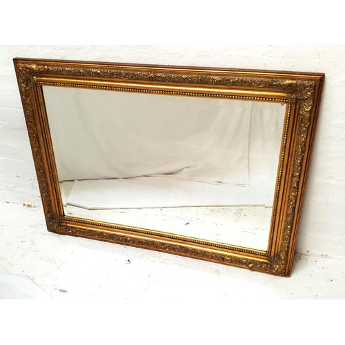 447 - RECTANGULAR GILT FRAMED WALL MIRROR
with a bevelled plate, 79cm x 110cm