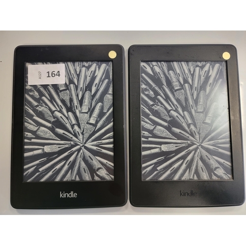 164 - TWO AMAZON KINDLE E-READERS
comprising a Paperwhite 3, serial number G090 G105 7336 0ANU; and a Pape... 