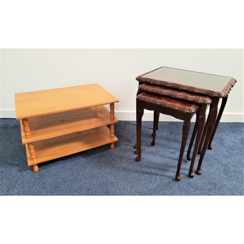 376 - NEST OF THREE MAHOGANY TABLES
each with an inset glass top, standing on cabriole supports, 56cm high... 