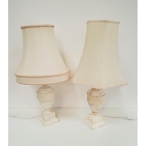 438 - MATCHED PAIR OF CREAM ALABASTER LAMPS
raised on square bases with urn shaped bodies and cream fabric... 