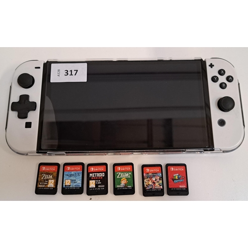 317 - NINTENDO SWITCH 
s/n XTJ10450885331, in a protective case, with six games comprising Super Mario Ody... 