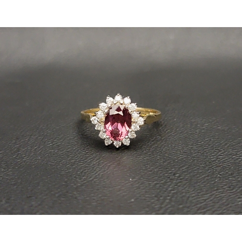 82 - PRETTY RHODOLITE AND DIAMOND CLUSTER RING 
the central oval cut rhodolite measuring approximately 1c... 