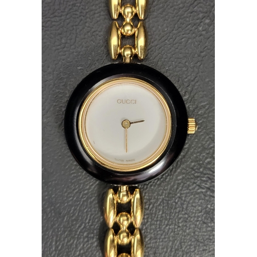 61 - LADIES GUCCI WRISTWATCH
with six interchangeable bezels and gold plated bracelet strap, the back num... 