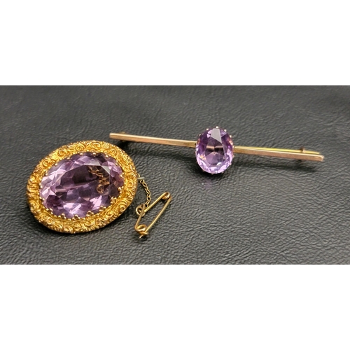 85 - TWO AMETHYST SET NINE CARAT GOLD BROOCHES 
one with large central oval cut amethyst measuring approx... 