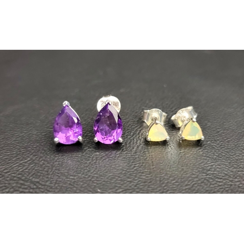 90 - TWO GEM SET RINGS AND MATCHED PAIRS OF EARRINGS
comprising an amethyst three stone ring together wit... 