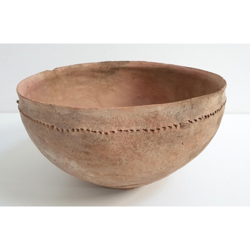 140 - BRONZE AGE POTTERY BOWL
with incised finger decorated border, possibly Jordanian, 28cm diameter