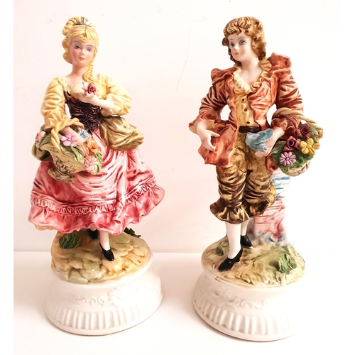 175 - PAIR OF ITALIAN FIGURINES
depicting a man and lady, raised on circular bases and both carrying a bas... 