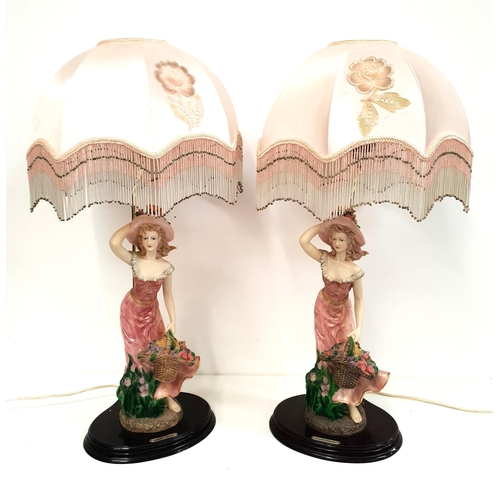 218 - PAIR OF DANIELLO COLLECTION RESIN TABLE LAMPS
modelled as a lady in a flowing dress with a basket of... 