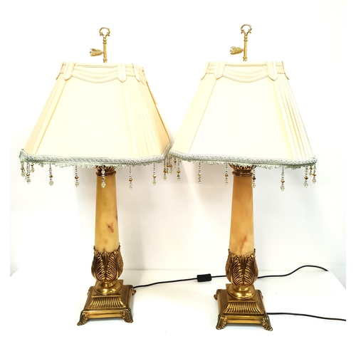 414 - PAIR OF ORNATE LAMPS
raised on square brass bases with tapering faux marble columns and decorative s... 