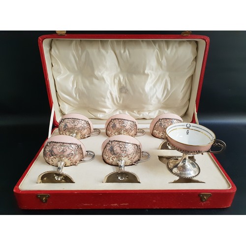 127 - SET OF SIX GEORGE V SILVER CUPS
raised on a circular foot with a pierced bowl and scroll handle, eac...