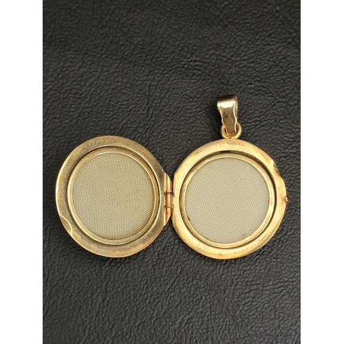 97 - EIGHTEEN CARAT GOLD CIRCULAR LOCKET PENDANT
with engraved floral decoration, 3.6cm high including su... 