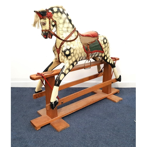 252 - 20th CENTURY WOODEN ROCKING HORSE
with a dapple grey body and red corduroy saddle with adjustable le... 