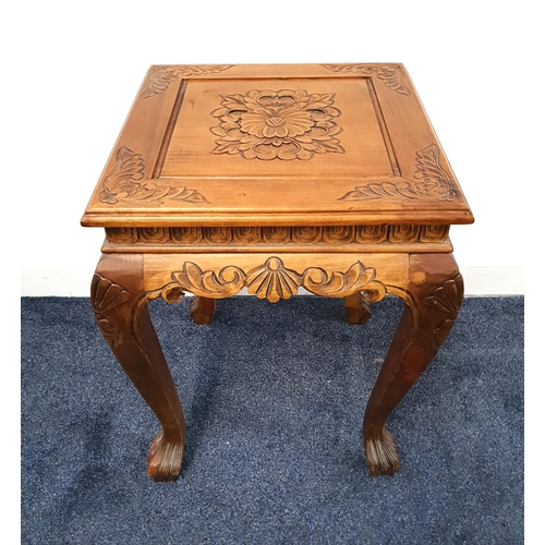 433 - CARVED TEAK OCCASIONAL TABLE
with a square top decorated with a central flower head above a carved a... 