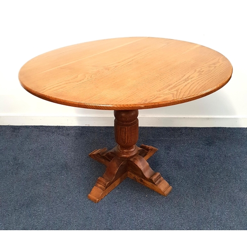 436 - OAK KITCHEN TABLE
with a circular top on a turned column with four flattened feet, 74cm x 106cm