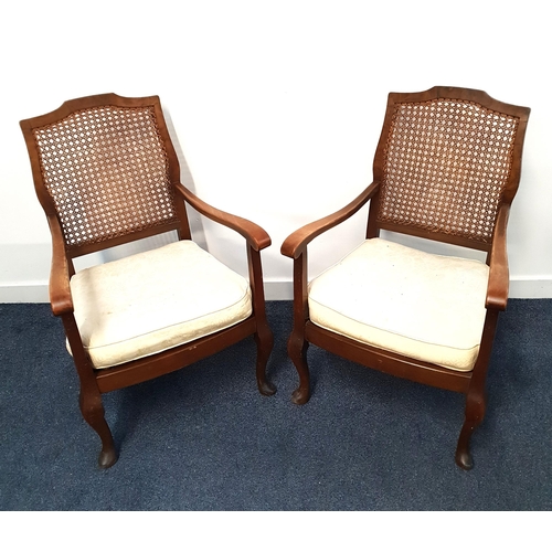 438 - PAIR OF WALNUT ARMCHAIRS
with shaped caned backs above sprung seats with cushions, standing on cabri... 