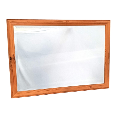 444 - PINE RECTANGULAR WALL MIRROR
with a cushion frame and bevelled plate, 70.5cm x 102cm