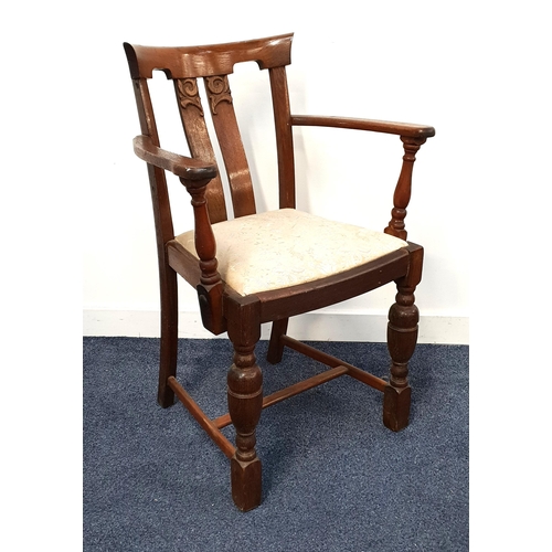 449 - 1930s OAK ELBOW CHAIR
with a carved top rail above a slatted back and shaped arms, above a sprung se... 