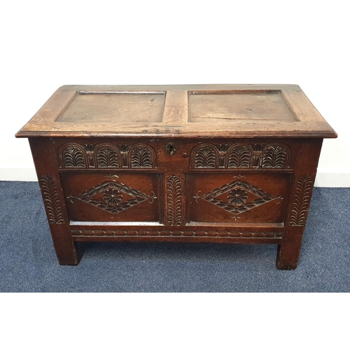 341 - 17th CENTURY CARVED OAK COFFER
with a panelled lift up lid above a carved frieze with a pair of carv... 